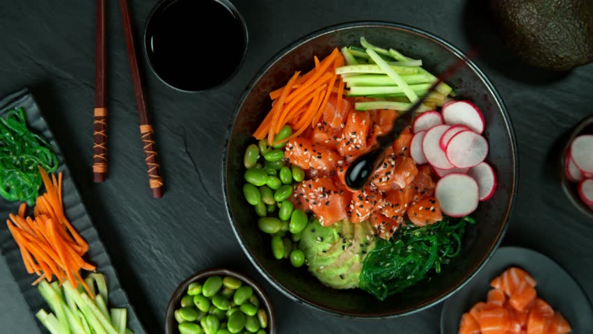 Super Slow Motion Shot of Soy Sauce Falling and Splashing into Salmon Poke Bowl at 1000fps. Royalty-Free Stock Footage #1099832201