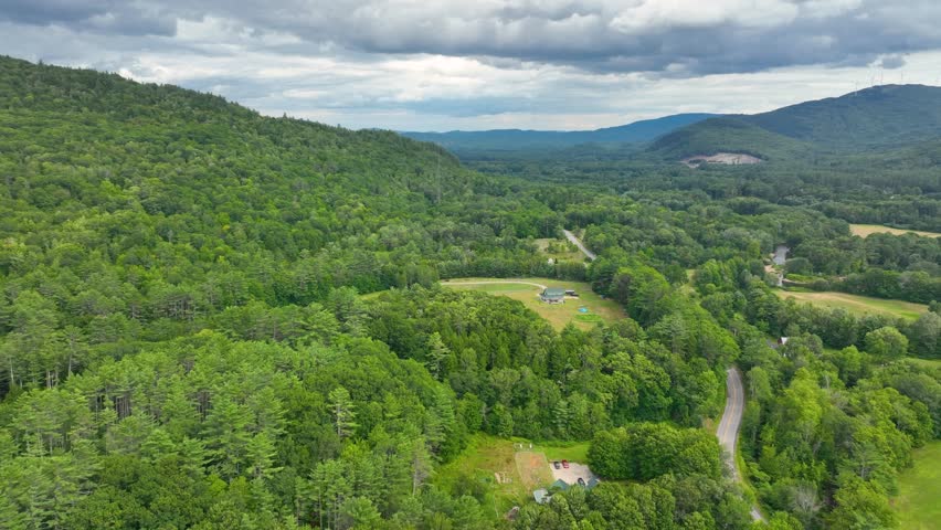 Stinson Mountain, Tenney Mountain and Baker River valley between them from top of Rumney historic center aerial view in summer in White Mountain National forest, Rumney, New Hampshire NH, USA. 