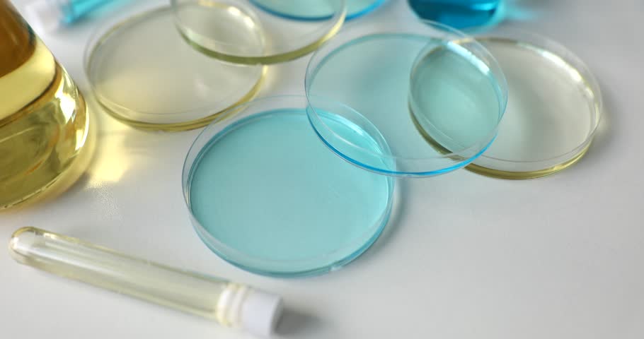 Glass medical laboratory flasks with different colorful liquids and glass bowl | Shutterstock HD Video #1099834195
