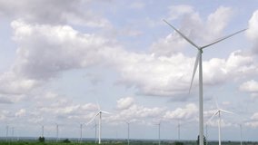 Progressive way of utilizing wind as renewable source of energy to power the modern way of life by wind turbine farm on green field or hill. Windmill generator generate electric with no CO2 emission. - Powered by Shutterstock - Get 15% off with code: PIKWIZARD15