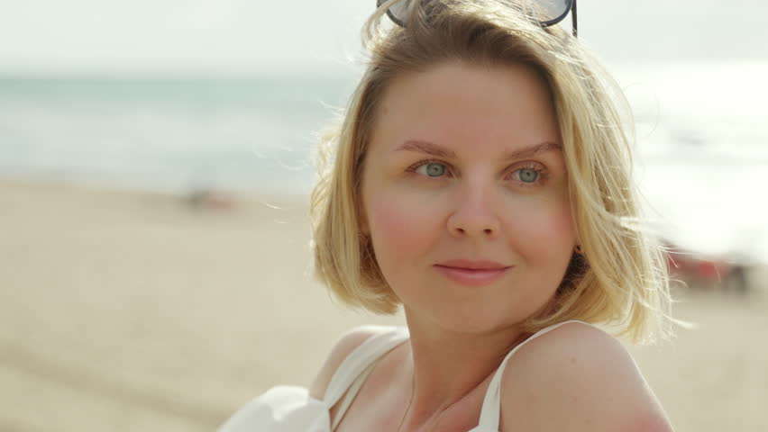 4k 10bit close up footage of a blonde european women by the  beach. ProRes 422 LT 10 bit 4k | Shutterstock HD Video #1099840835