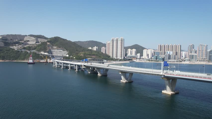 Large-scale sea traffic viaduct bridge Cross Bay Link landmark in Lohas Park,Tseung Kwan O of Hong Kong city, Kowloon Kai Tak Aerial Top skyview | Shutterstock HD Video #1099841087