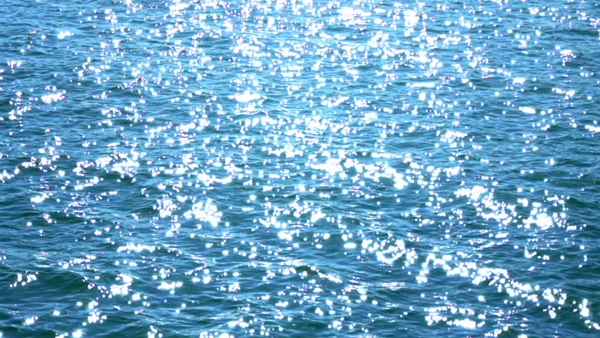 White glare on sea water or ocean. Sun glare and light reflection on lake water's surface at sunset, blue texture. Background with blue white reflection. Water treatment and drinking water. Royalty-Free Stock Footage #1099844795