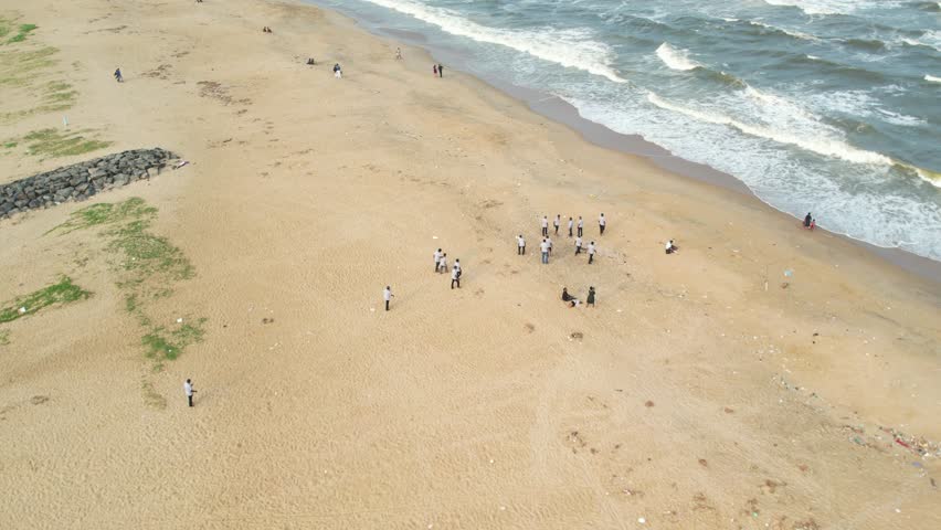 Aerial view of a town of fishermen playing in beach Chennai