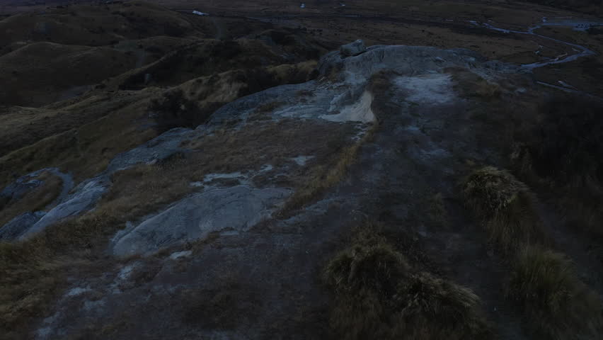 Mount Cook and neighboring mountains during sunset overlooking the valley and flowing rivers seen behind