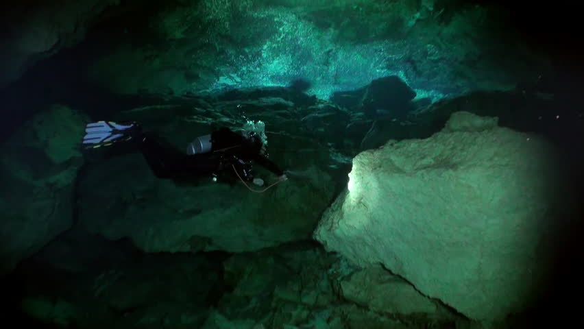 View from under clear water to trees and tree roots and ray of suns in cave of underwater Yucatan Mexico cenotes. Cave diving. Unique beautiful video footage of wildlife in underwater world. | Shutterstock HD Video #1099847289