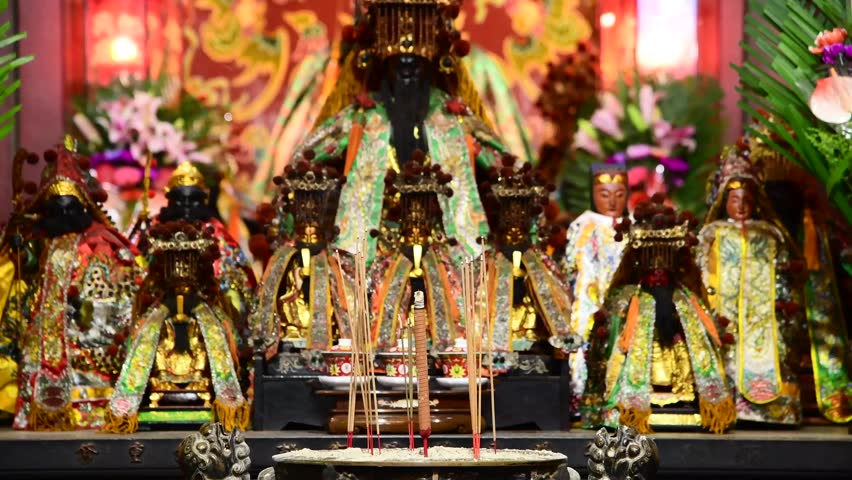 Believers insert incense sticks on incense burners at Sacrificial Rites Martial Temple in Tainan, Taiwan. Royalty-Free Stock Footage #1099847741