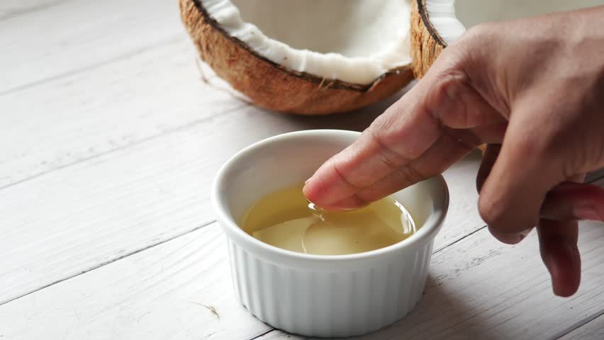 Close up of coconut oil in a container on table  | Shutterstock HD Video #1099853173