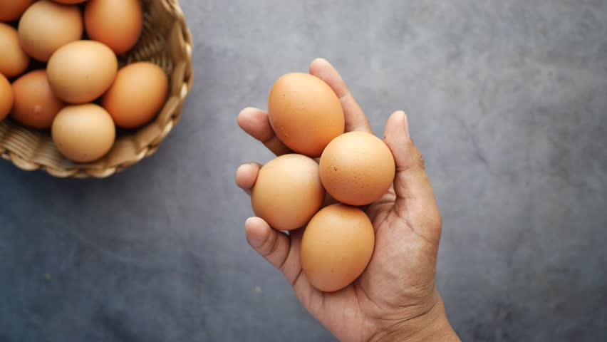 Hand pick eggs from a plastic case on table  | Shutterstock HD Video #1099853177