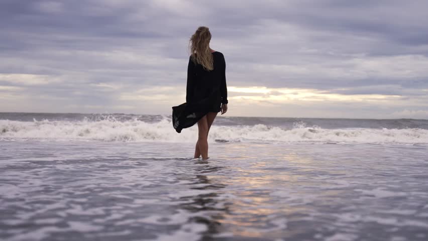 Woman looking at ocean view at sunset thinking about life Girl relaxing in nature enjoying afternoon peace and calm landscape nature background enjoying vacation travel