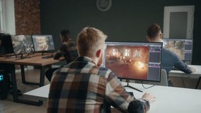 multi ethnic group of game designers working in office or coworking space, developing new video game