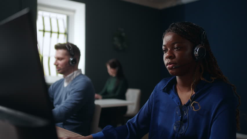 african woman working in call-center or telemarketing department, consulting and helping line