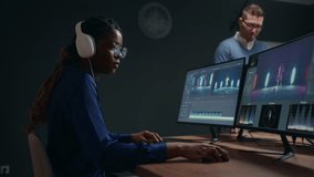 professional video editor and colorist woman creating new musical clip in studio, sound design