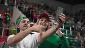Cute fans couple take selfie photo sport soccer stadium. Happy emotion lovers enjoy romantic love date. Smile guy man win football bet. Romance joy together. Fun girl shot selfies blog mobile phone. - Powered by Shutterstock - Get 15% off with code: PIKWIZARD15