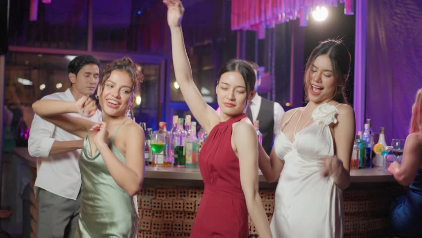 Asian beautiful woman having fun, dancing with music in bar restaurant. Attractive young girl in red dress feeling happy and relax having a party, drinking alcohol to celebrating event at night club. | Shutterstock HD Video #1099861639