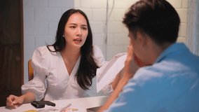 Asian young depressed couple having argument while checking money debt. Attractive new marriage man and woman looking frustrated to paperwork and bill, feel worried about financial problem in house. - Powered by Shutterstock - Get 15% off with code: PIKWIZARD15