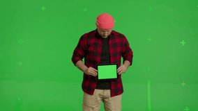 man showing tablet standing on green screen background