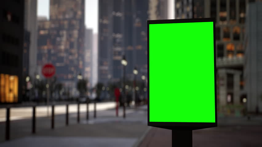 Modern billboard with a green screen for advertising on a busy crossroad street with traffic and skyscrapers, timelapse of traffic at sunset. Loop video. Royalty-Free Stock Footage #1099866819