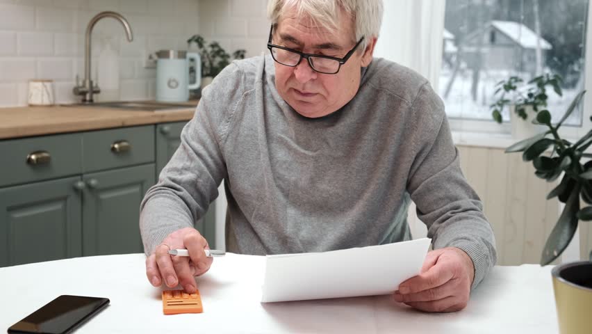 Senior Man Checking Calculating Personal Finance at Home, Feeling Stress from Money Problem. Concerned Elderly Male get Official Bank Notification, Financial Bill, Unpaid Debt or Tax and Feel Worried | Shutterstock HD Video #1099867763