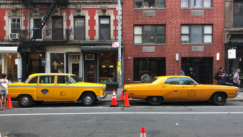 NEW YORK, NEW YORK – JULY 01: Checker Cab and Classic Yellow Taxi are parked on the street at East Village for Movie or TV shooting on July 1, 2022 in New York, NY, USA.