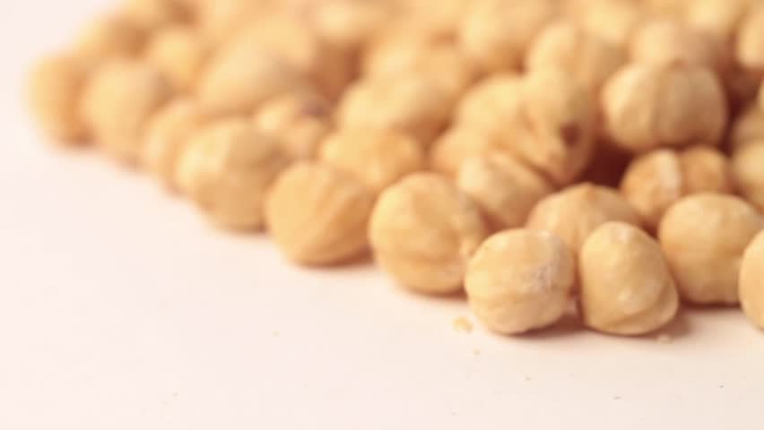 Close up on hazelnuts shot in a studio, no people are visible.