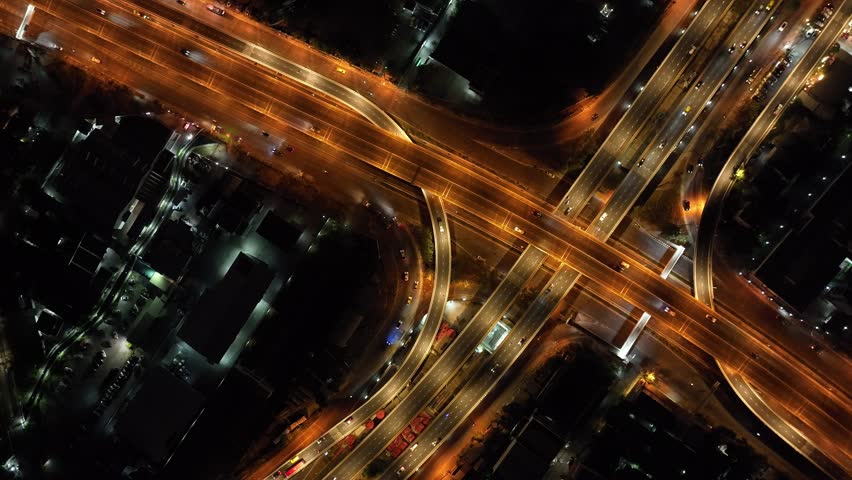 Expressway top view, Road traffic an important infrastructure, car traffic transportation above intersection road in city night, aerial view cityscape of advanced innovation, financial technology | Shutterstock HD Video #1099871261