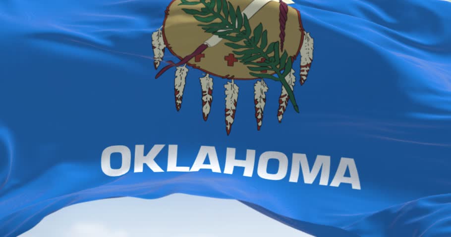 Oklahoma state flag waving. Oklahoma is a state in the South Central region of the United States. Rippled fabric. Textured background. 3d render animation. Close-up. Selective focus. Slow motion loop