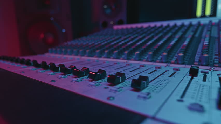 Part of large sound board with many consoles for adjusting details of new music during process of creating and recording it by musicians in modern studio | Shutterstock HD Video #1099878101
