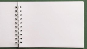 Flat lay of open blank empty spiral sketchbook notebook notepad with ring binder. Pages turning endless. Art, drawing, creativity, education, paper, memory, message, notes, information. Stop motion. - Powered by Shutterstock - Get 15% off with code: PIKWIZARD15