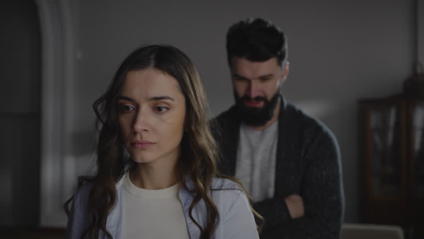 Young humiliated woman closes ears during quarrel with her husband reproaching her, expressing aggression towards her. Family and couple relationships difficulties. Domestic violence and abuse concept Royalty-Free Stock Footage #1099880441