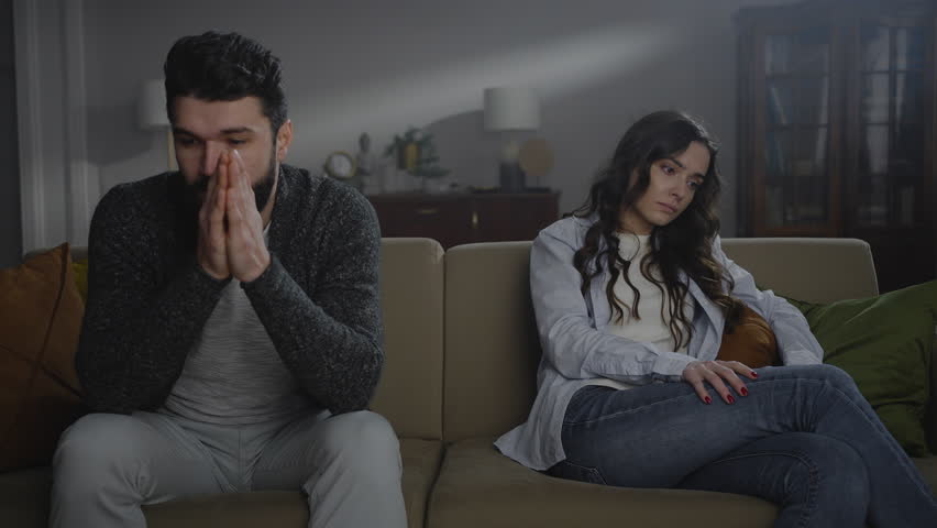 Young man trying to make peace with his angry girlfriend or wife, after quarrel. Young woman feeling herself offended denying any contact with her husband. Family relationships difficulties and crisis Royalty-Free Stock Footage #1099880487