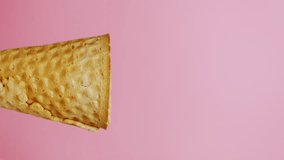 Vertical slow motion video, scooping chocolate chip ice cream in a cone on pink background, delicious ice cream concept.