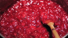 Cooking And Stirring Cranberry Sauce With Wooden Spoon. Thanksgiving Staple Food. closeup - Powered by Shutterstock - Get 15% off with code: PIKWIZARD15