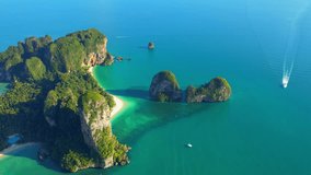 Drone is flying over the tropical sea. limestone mountains and long-tail boats. Ao Nang, Krabi, Thailand. Most Beautiful Places In Thailand. High quality stock video. Travel and holiday concept. 4K
