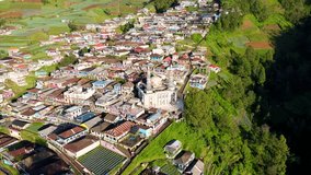 Drone shot of Beautiful rural landscape and mosque with 2 minarets located on the slope of Mount Sumbing, Indonesia - Baituttaqwa mosque on Nepal Van Java, Indonesia