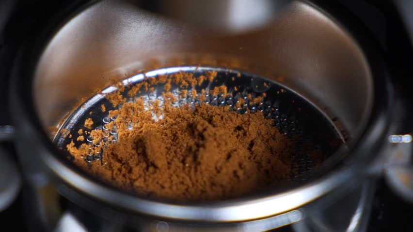 ECU coffee being ground into a espresso filter handle. | Shutterstock HD Video #1099893381