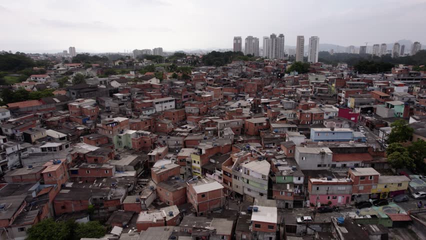 Aerial view overlooking a slum neighborhood, in Sao Paulo, Brazil - circling, drone shot