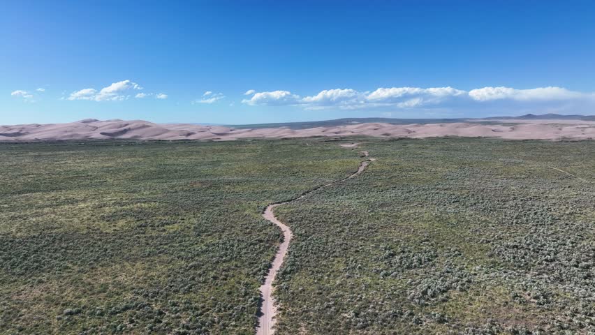 Trail Through Lush Landscape Heading To St. Anthony Sand Dunes In Idaho, USA. wide aerial