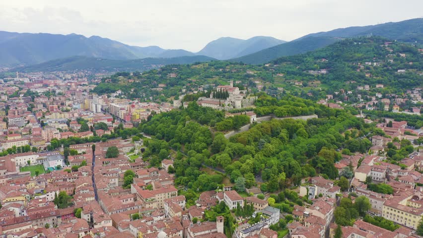 Inscription on video. Brescia, Italy. Castello di Brescia. Flight over the city in cloudy weather. Text furry, Aerial View, Point of interest