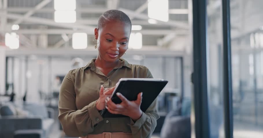 Communication, typing and black woman with a tablet for social media management at a startup. Website, contact and African employee reading information on technology for connection and email | Shutterstock HD Video #1099896457