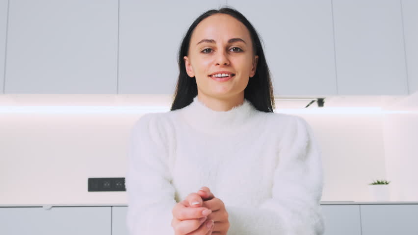 Young brunette woman looks to the camera and emotional talks