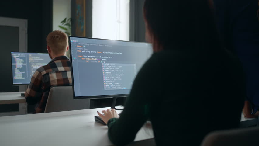 Data scientist and data analyst working in office, view through shoulder male and female specialists | Shutterstock HD Video #1099905223