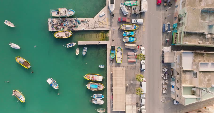 Tradition fishing boats on the sea and coastline, Marsaxlokk village. Malta 