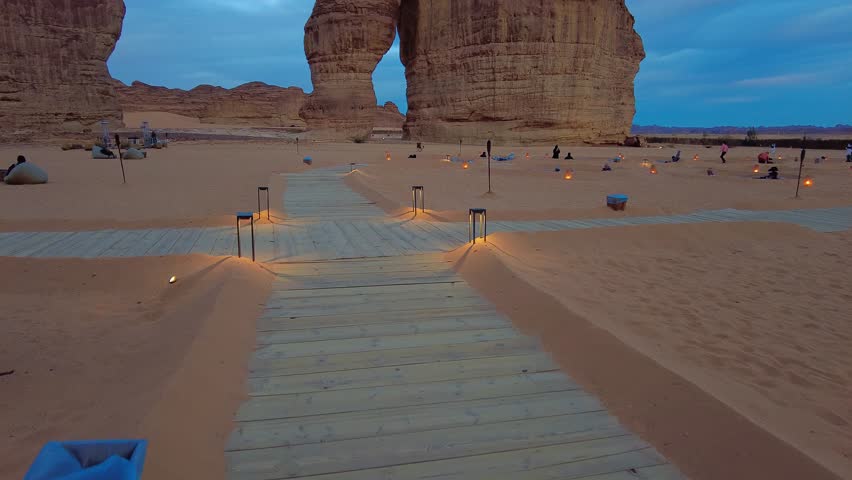 Al Ula, Saudi Arabia: Dramatic view of the Elephant rock and cafe at sunset in the Alula area in Saudi Arabia. Shot with a tilt up motion Royalty-Free Stock Footage #1099906343