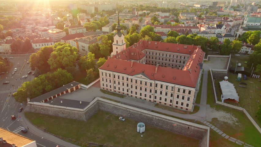 Aerial view of the Rzeszow Castle at sunset, Subcarpathian Voivodeship, Poland. Drone footage of Renaissance building of Rzeszow castle with Rzeszow cityscape in summer, Poland. Orbit shot
