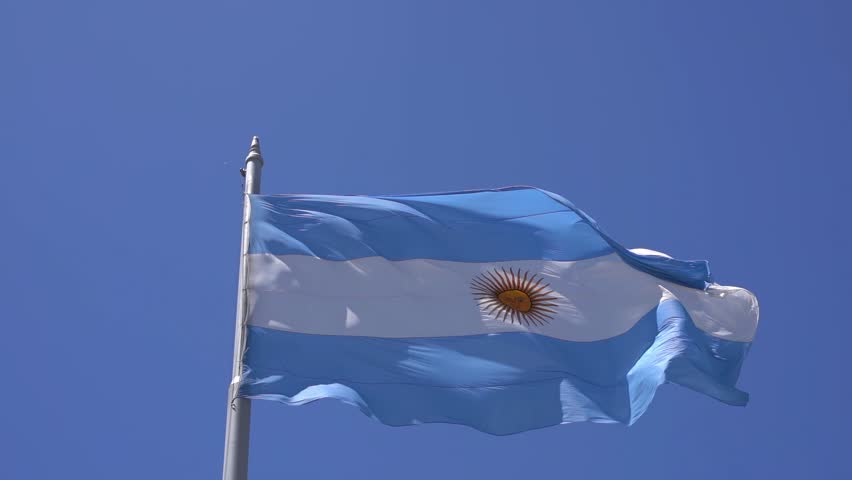 Argentinean flag against the blue sky in Buenos Ares. The national blue and white flag of Argentina.