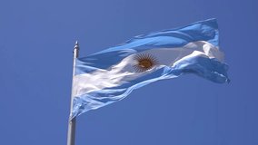 Argentinean flag against the blue sky in Buenos Ares. The national blue and white flag of Argentina. - Powered by Shutterstock - Get 15% off with code: PIKWIZARD15