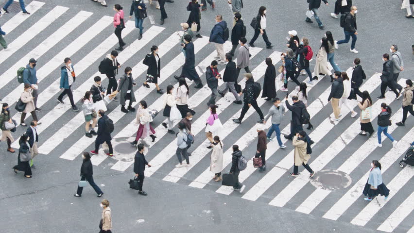 Crowded Japanese people, Asian traveler walk cross road at Shibuya scramble crossing. Tokyo tourist attraction, Japan tourism, Asia transport, commuter transportation or city life concept. Slow motion Royalty-Free Stock Footage #1099919983