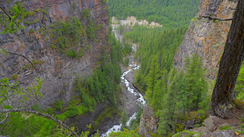 Establishing shot of majestic mountain river with mountain background in Vancouver, Canada, North America. Day time on April 2022. Still camera view. ProRes 422 HQ.