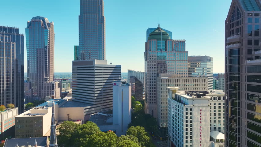 Aerial view of downtown district of Charlotte city in North Carolina, USA. Glass and steel high skyscraper buildings in modern american midtown.